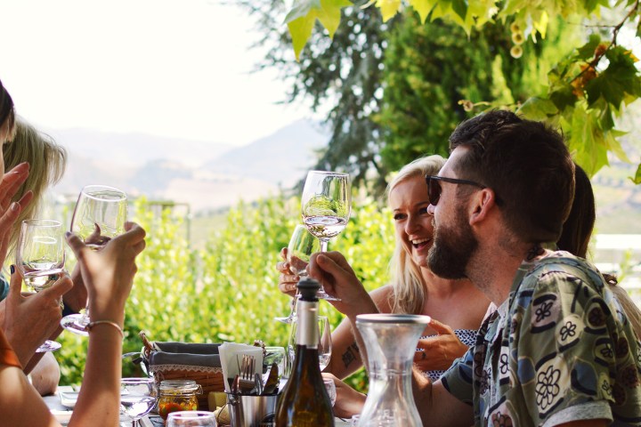 a group of people sitting at a table with wine glasses